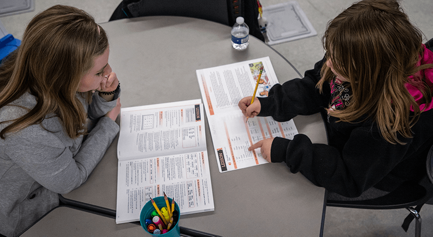 CMU students helping a child with reading