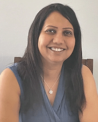 Kalpana Joshi, a graduate from the Doctorate in Educational Technology program at Central Michigan University, in a blue blouse.