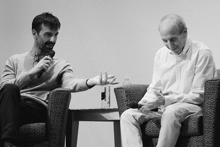 Ned Scott Laff (right) and a student seated at a table with a laptop in the CLASS Hub