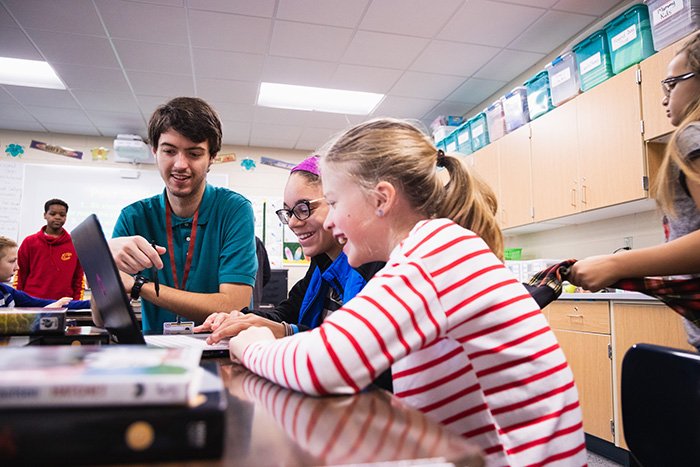 English education student meets with students at a local elementary school