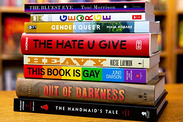 Closeup image of stack of banned books on tabletop.