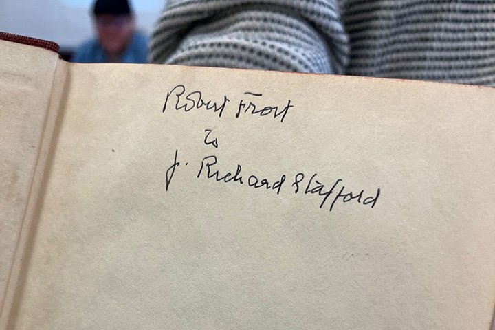 Jett W. Whitehead holds a book signed by Robert Frost