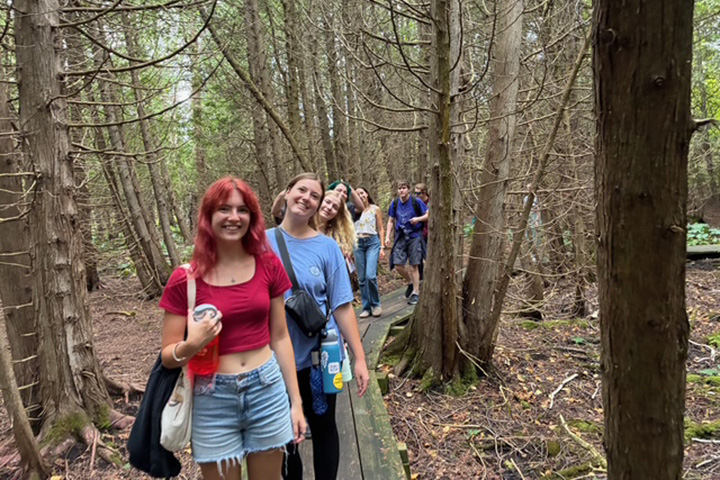 Students in Professor Robert Fanning’s English course, “Wonder and Wonder,” walk along a forest trail on Beaver Island