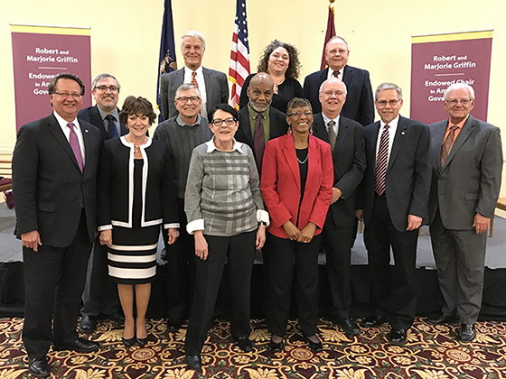 Past Griffin Endowed Chairs and Central Michigan University faculty dressed in business professional attire posing for a group picture.