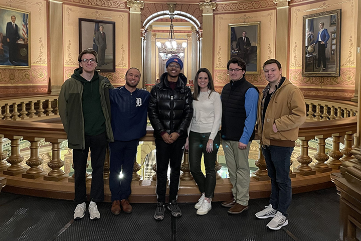 Andrea LaFontaine (third from right) stands inside the Michigan State Capitol with five Central Michigan University students.