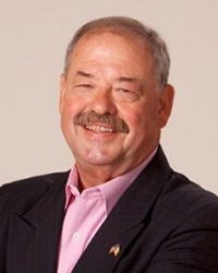 Former Lt. Governor John Cherry wearing a dark suit jacket and pink shirt.