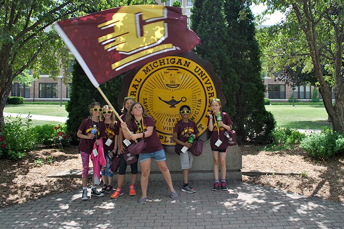 Curious Curators 2018 700x467 Curious Curators wave a CMU flag in front of the CMU Seal