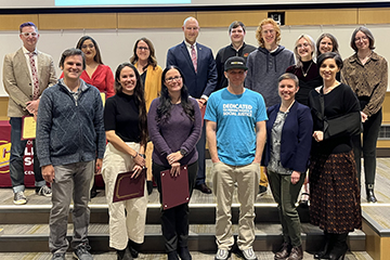 Recipients of the CLASS alumni, student paper, and faculty teaching and diversity awards stand in two rows on steps.