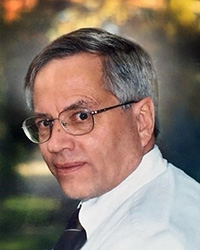 Image of Gary Fuller wearing glasses and a white shirt and tie