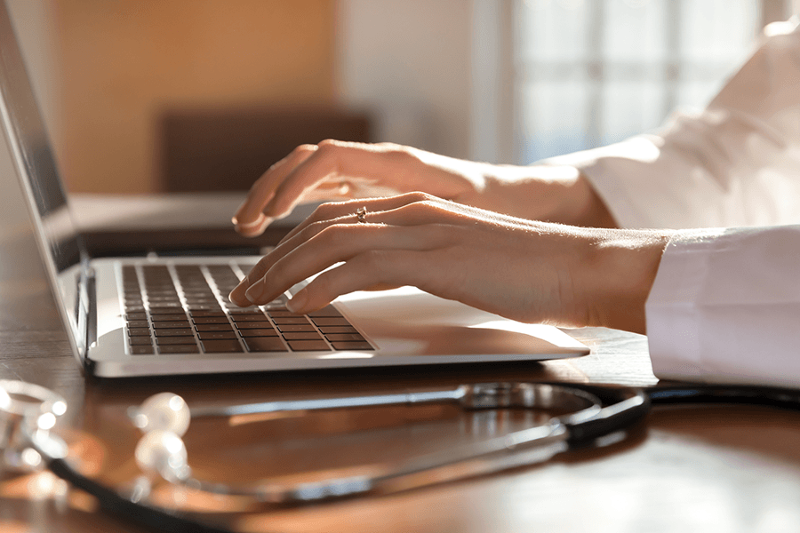 A student typing on her laptop