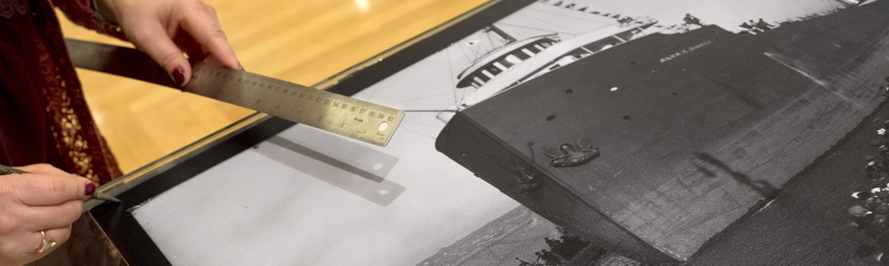 Student working with a black and white image of a ship going through the Soo Locks