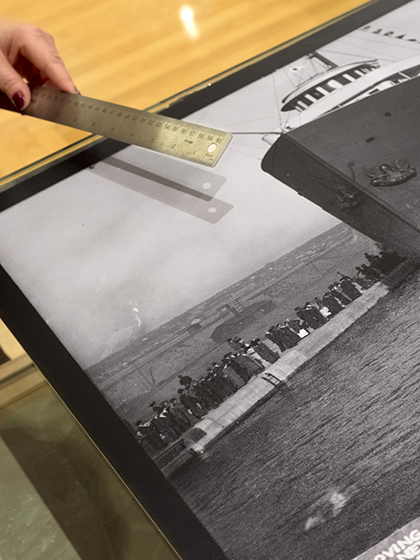 Student working with a black and white image of a ship going through the Soo Locks