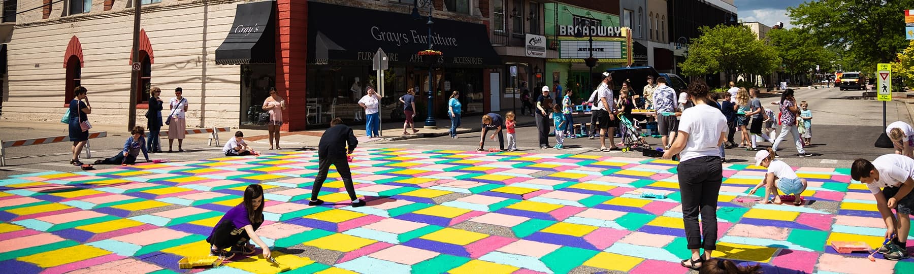 Families paint the street in bright blocks of color in downtown Mt. Pleasant