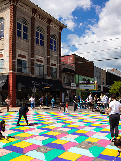 Families paint the street in bright blocks of color in downtown Mt. Pleasant