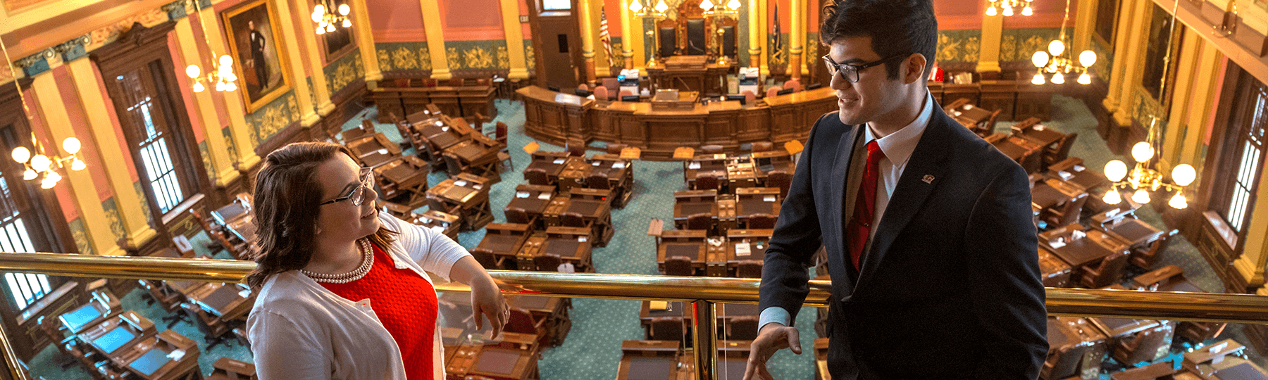 Central Michigan University student interns stand inside the Michigan State Capitol