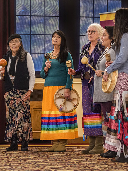 Women playing Native American instruments
