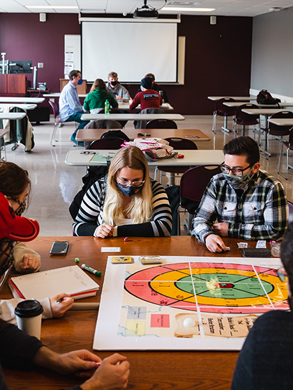 Students in the Game Design Thinking program playing a board game