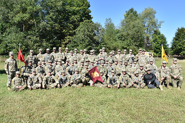 Military Science students pose with a Central Michigan University flag