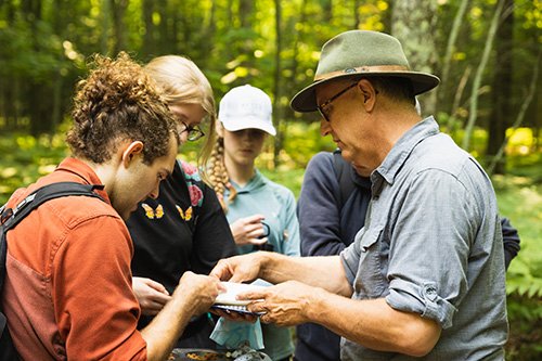 CMU biology faculty member in the field with students on Beaver Island.