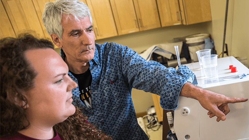 A man and woman looking at scientific data.