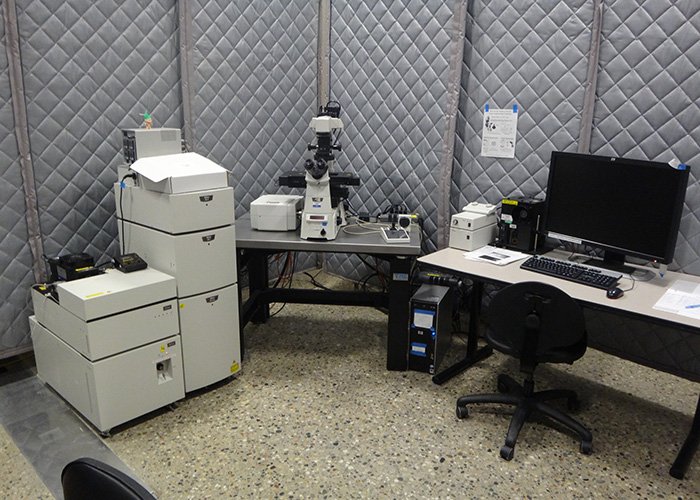 Nikon A1R Confocal Microscope on a desk next to a computer in the microscopy lab.