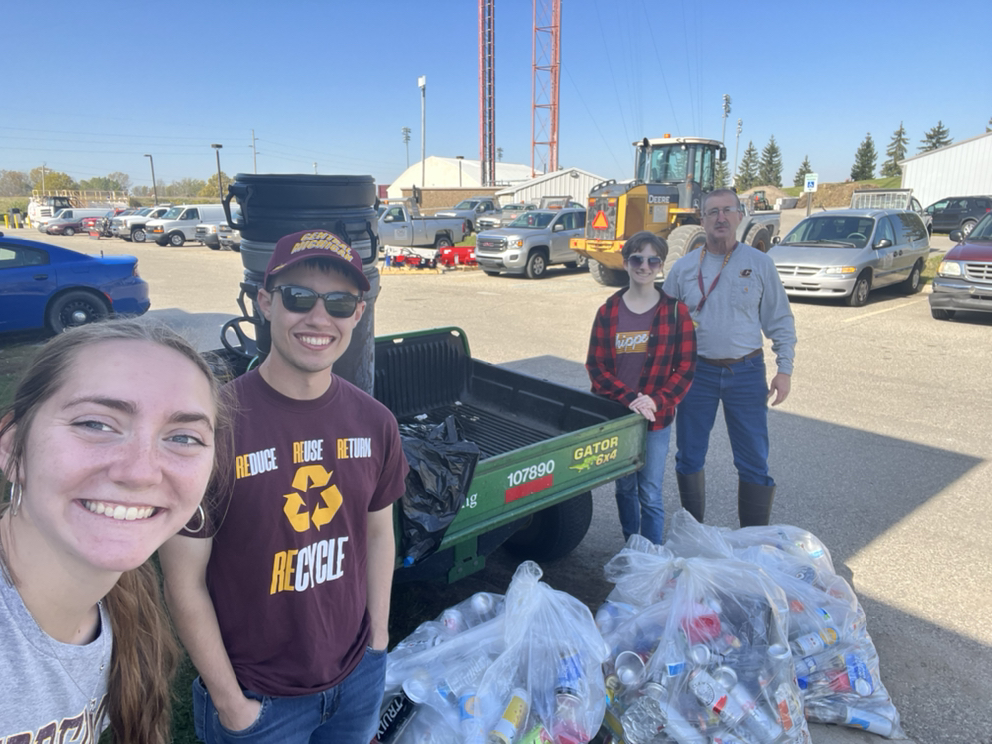 Central Sustainability students standing in front of a large amount of recycling