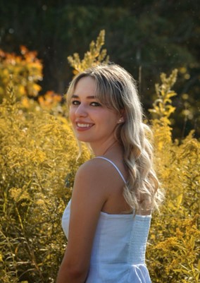 Tiffany Jurge in a blue dress in an outdoor meadow