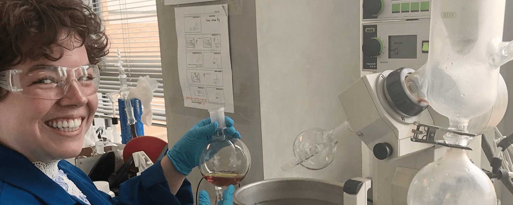 Madeline Clough holding sample in the Amino Acid Research Lab.