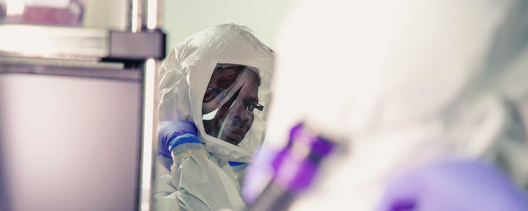 Nicholas Banahene in a hazmat suit in the TB lab.