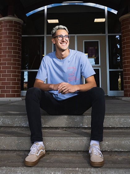 Walter Centeno sits on the steps for his Fired Up and Focused profile.