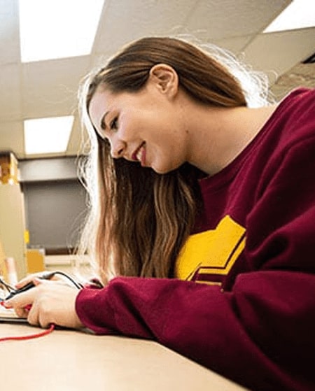 Julia Reynolds works in an electrical engineering lab on campus.