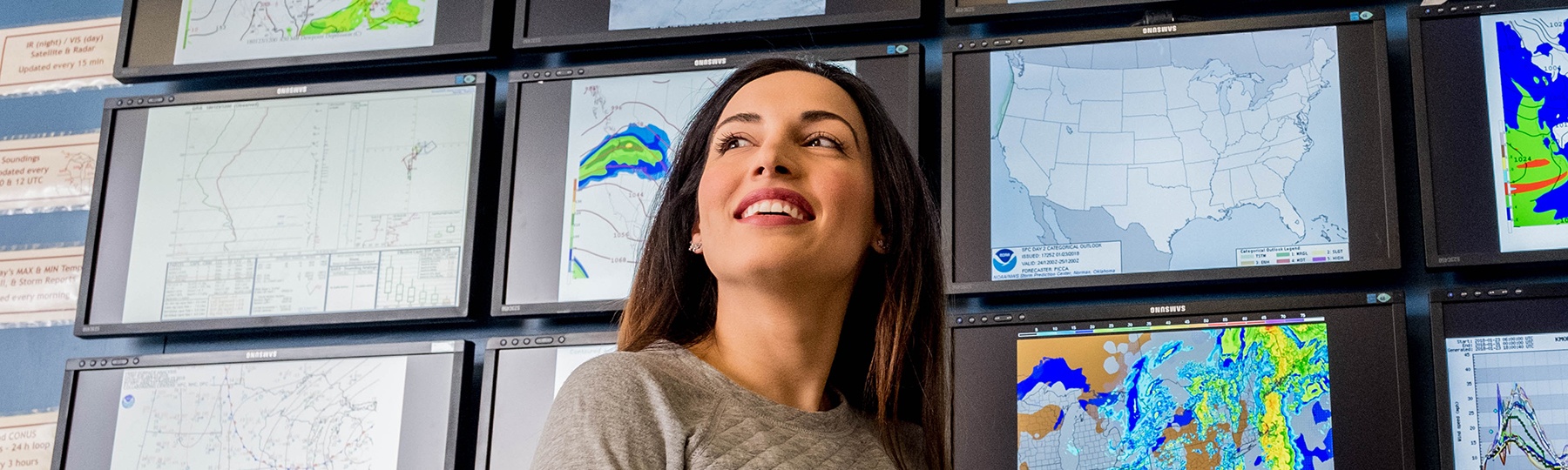 Meteorology student, Maria Molina, in front of the weather wall