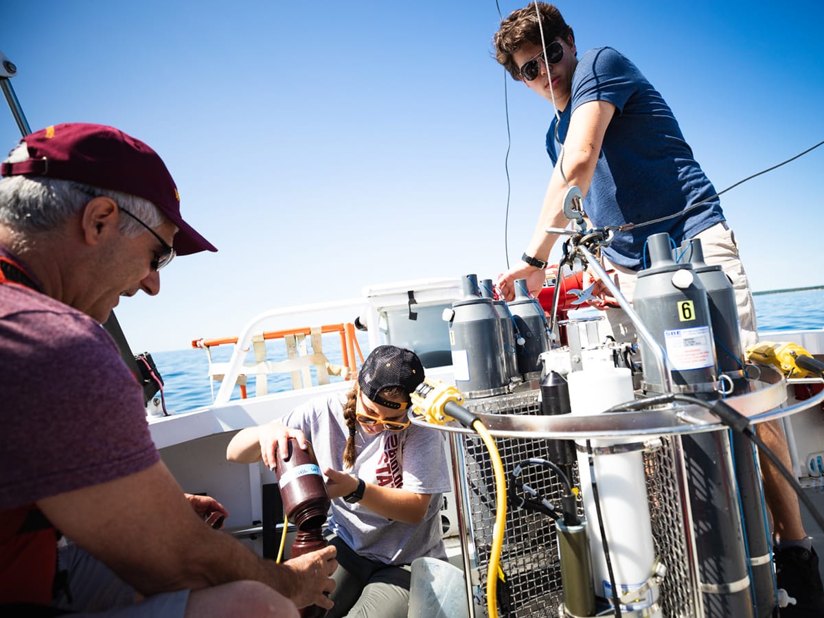 Students and faculty preparing equipment for water sampling aboard the MV Chippewa on Lake Michigan