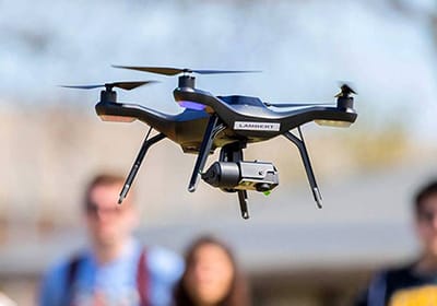 Students observe a drone flying during the a drone class.