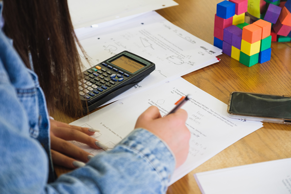 Student at a desk working on a mathematics problem in the mathematics assistance center