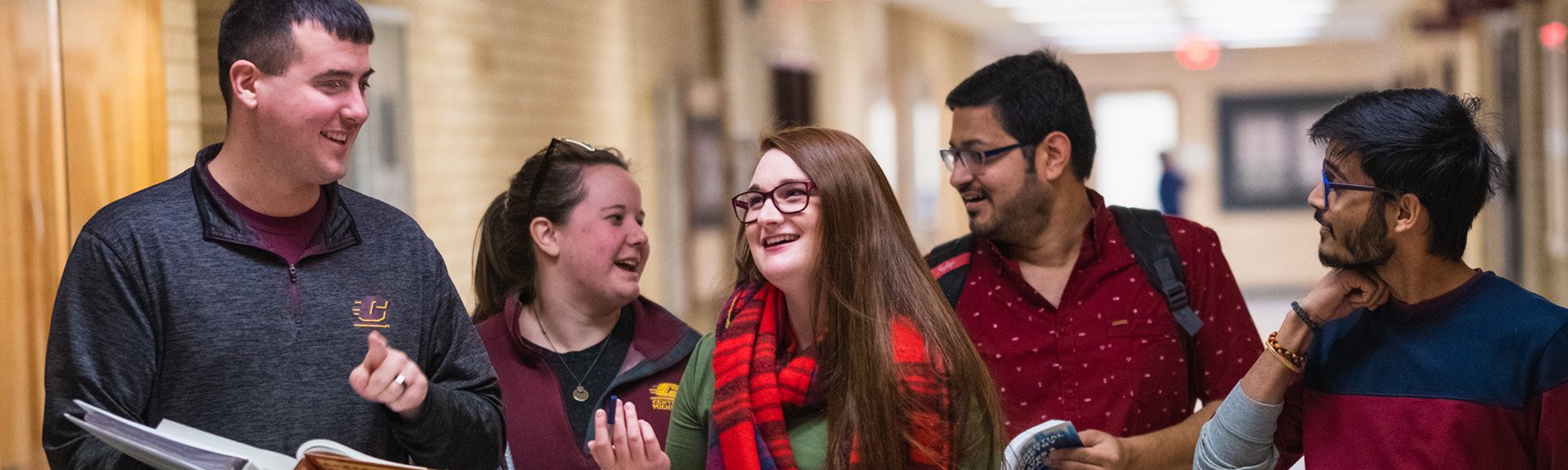 A group of mathematics students having a discussion in the hallway.