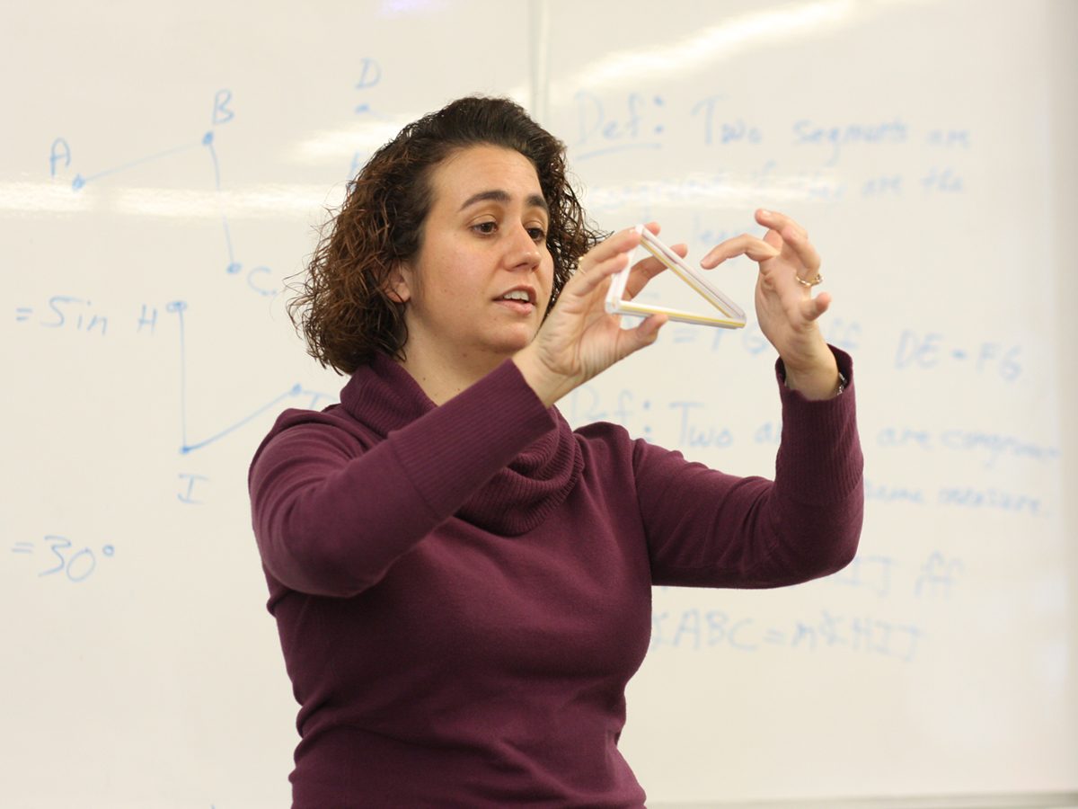 Katrina Piatek-Jimanez explaining formula in front of a class