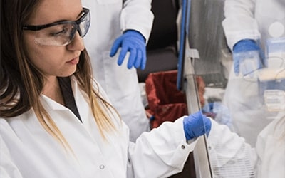 Neuroscience student examining samples in lab.