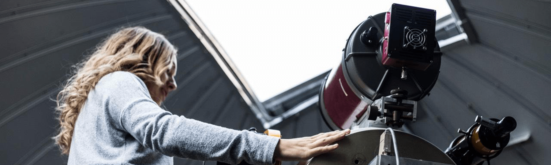 Student adjusting telescope in the Brooks Astronomical Observatory.