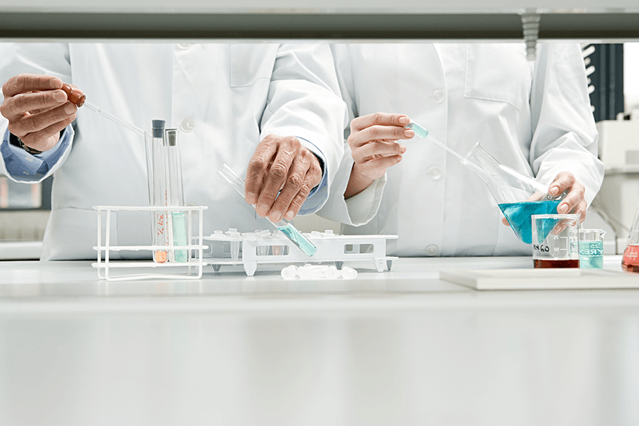 Chemists performing experiments in the chemistry lab.