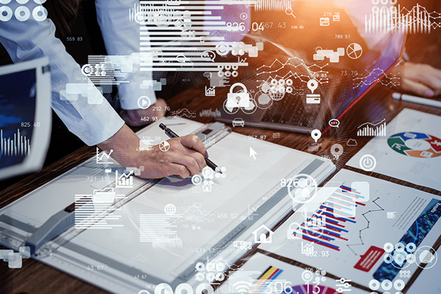 A person designing a product keeping various graphs and diagrams as reference.