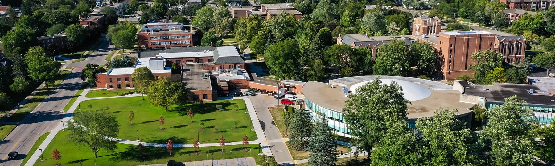 An aerial photograph of Central Michigan University's campus showing the University Center and green space.