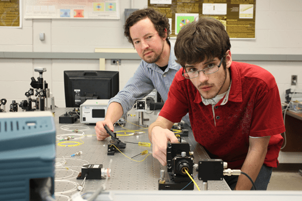 Students are setting up laser equipment in the optics lab.