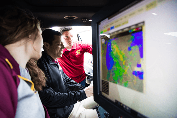 Students in the mobile mesonet examining weather maps.