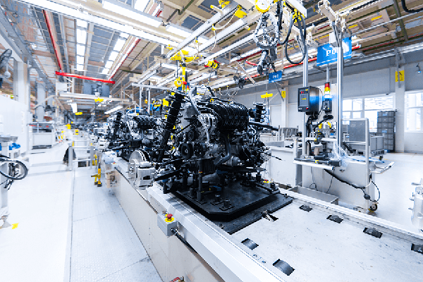 Mechanical equipment being assembled on an assembly line.