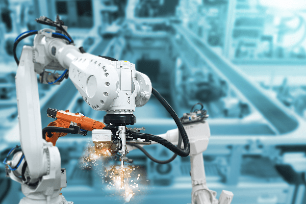 Robotic arms assembling items in a factory.