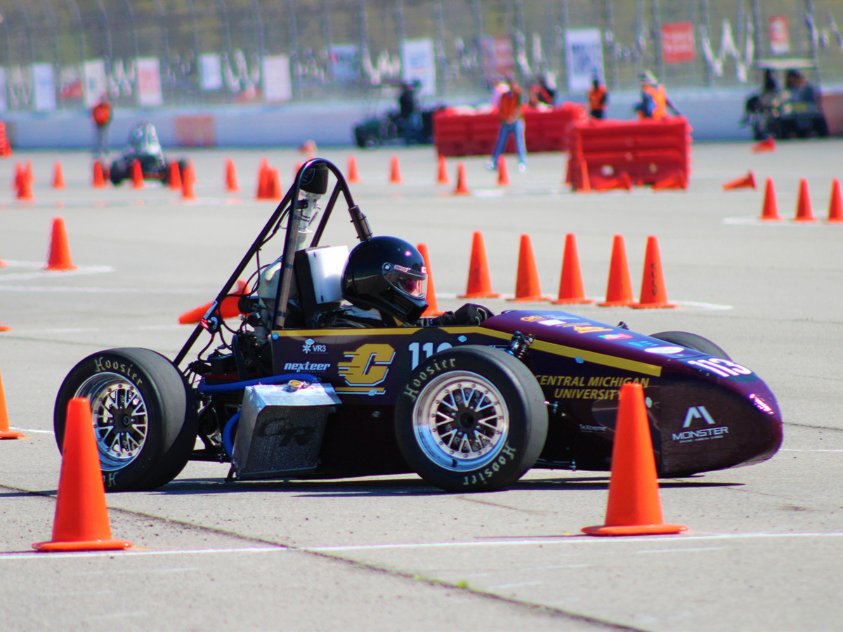 CMU Formula Racing car on the track surrounded by orange cones.