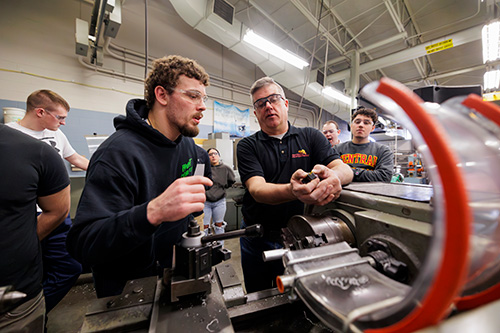 students and faculty in a robotics lab