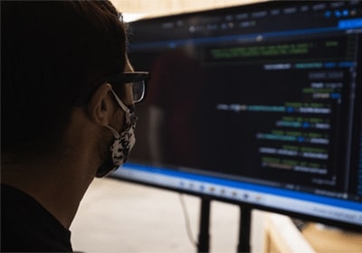 Statistics student examining computer screen full of statistical graphs.