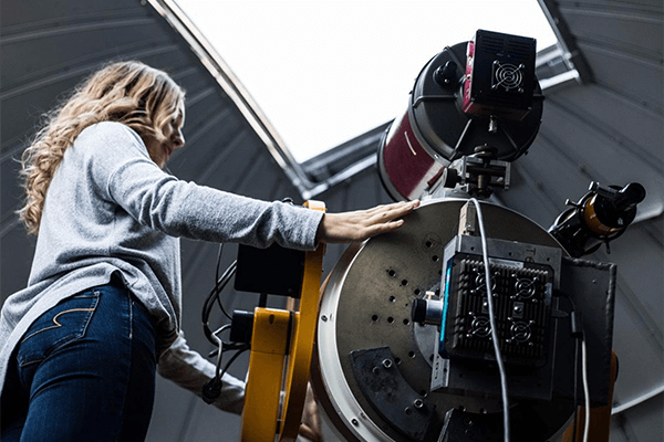 Student preparing large telescope in the Brooks Astronomical Observatory